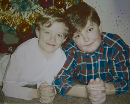 Paul and Jack smiling in front of a Christmas tree