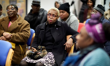 People seek information on delays to compensation payments to Windrush victims at a Home Office briefing in Manchester in January.