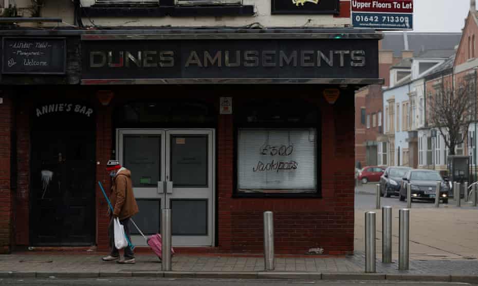 A man walks past a closed bar in Middlesbrough, north-east England