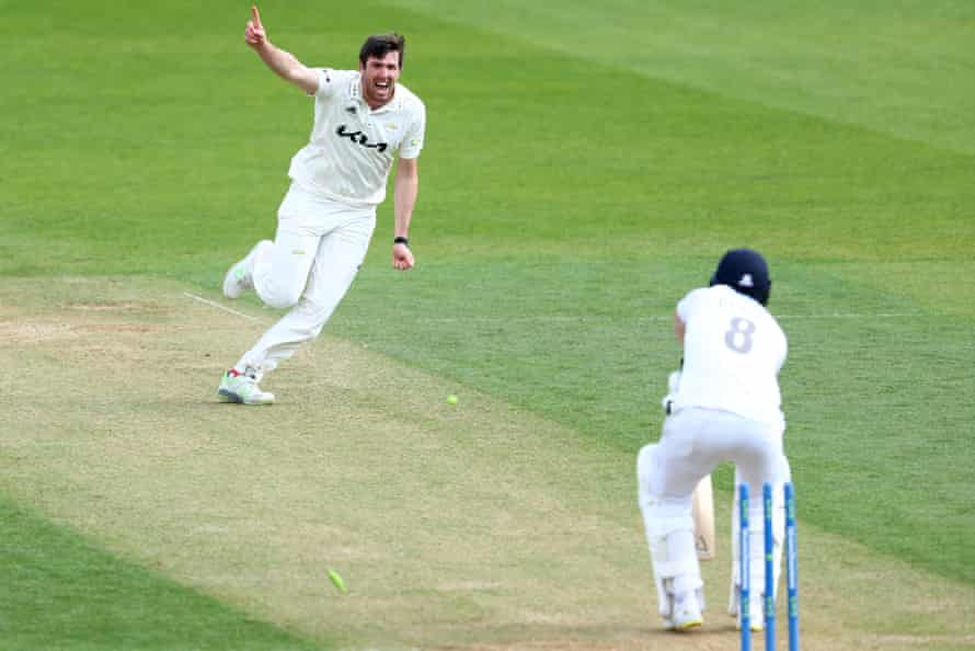 Jamie Overton of Surrey celebrates taking the wicket of Liam Dawson of Hampshire.