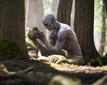 Jacob Elordi as the Creature, crouching down in woodland