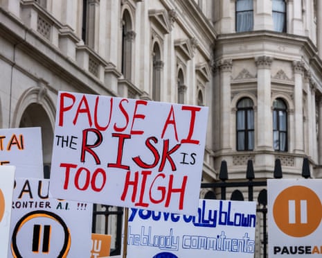 Placards reading 'pause AI, the risk is too high', 'pause frontier AI' and 'if you can't steer, don't race' are held against the railings on Whitehall