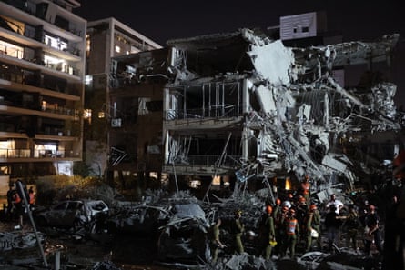 Israeli troops and first responders at a Tel Aviv building hit by a missile from Iran.