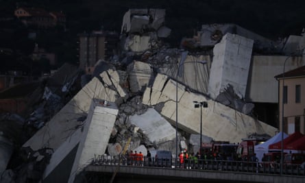Rescuers inspect the rubble of the Morandi bridge.