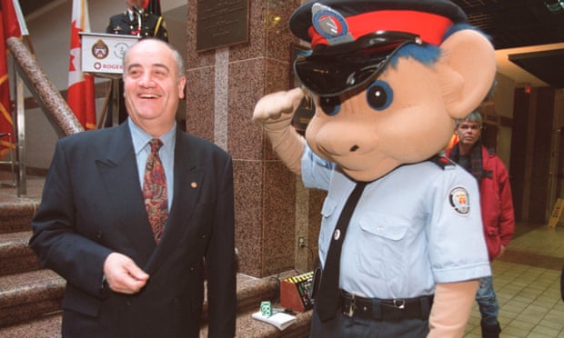 Fantino receives a salute from Officer Pat Troll, a mascot from a series shown to Catholic schoolchildren.