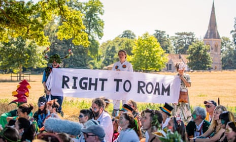 Protesters congregate at a large oak tree with a sign reading ‘Right to roam’