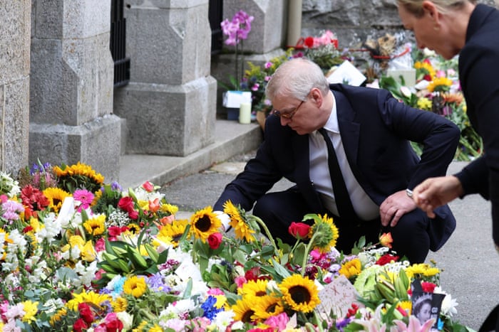 Prince Andrew inspects floral tributes outside Balmoral.