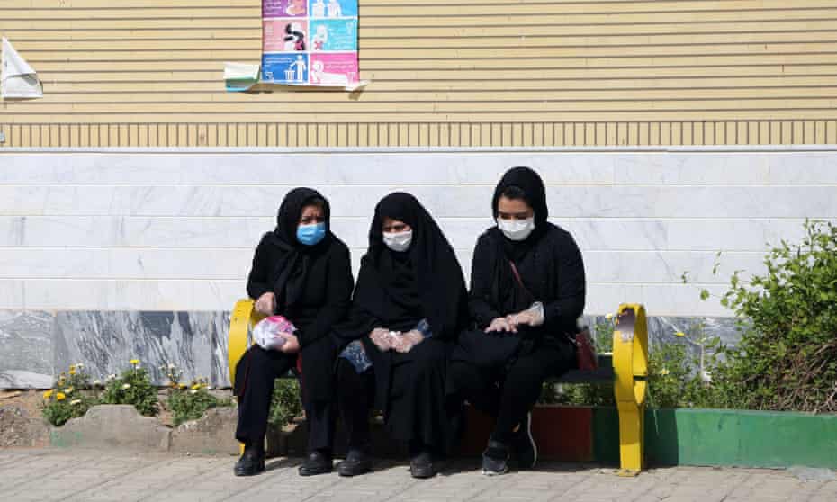 Mourners in face masks