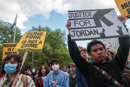 people hold signs saying ‘justice for jordan’ with michael jackson’s dancing legs pictured, and ‘being poor is not a crime’