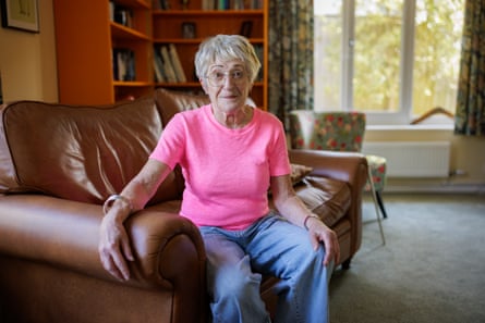 Trisha Fine sits on a sofa at home