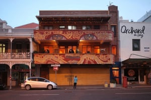 A woman stands outside a backpackers lodge in trendy Long Street, normally bustling with foreign tourists, as coronavirus lockdown regulations ease in Cape Town, South Africa, on 23 August, 2020.