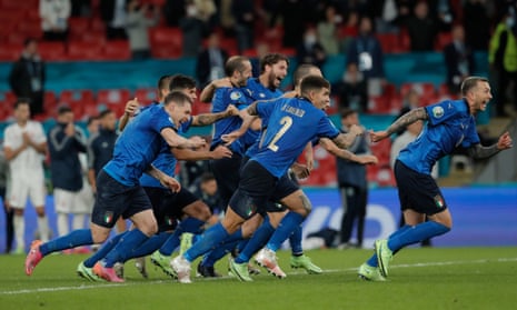 Italy players run to celebrate with Jorginho after his winning penalty in the shootout.