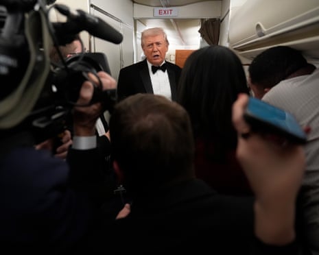 Donald Trump speaks with reporters aboard Air Force One as he travelled to West Palm Beach.