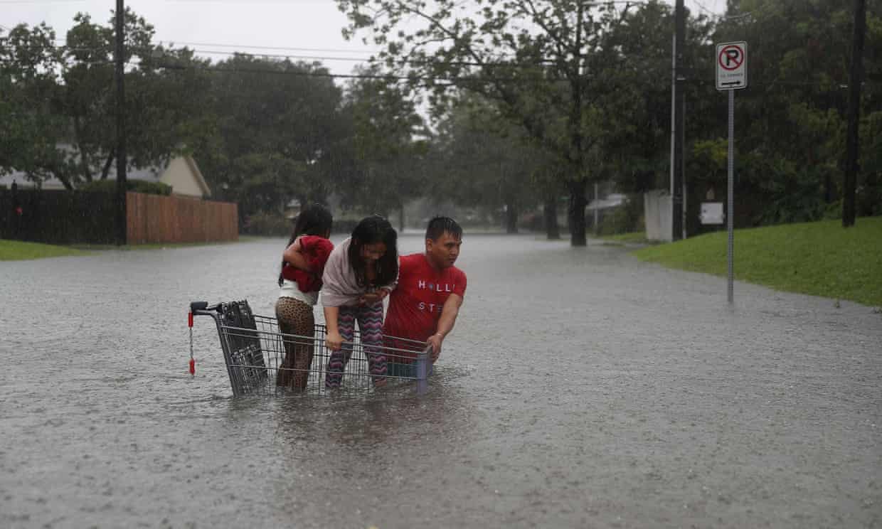 A family evacuate their home after flooding from Hurricane Harvey, Houston, Texas, 27 August