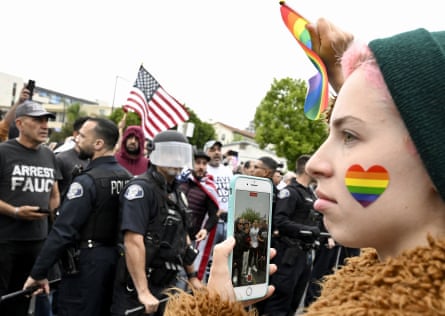 Conservative groups and LGBTQ+ rights supporters protest as police try to maintain order outside the Glendale Unified school district offices on 6 June.