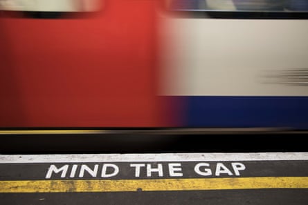 Mind the gap tube platform warning sign on a London Underground station platform