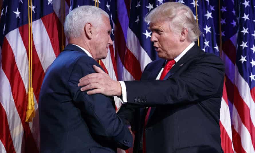 Donald Trump shakes hands with Mike Pence during an election night rally, 9 November 2016.