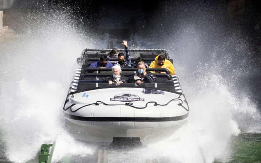 Guests ride Jurassic World: The Ride on reopening day of Universal Studios Hollywood in Universal City, California, on 15 April.