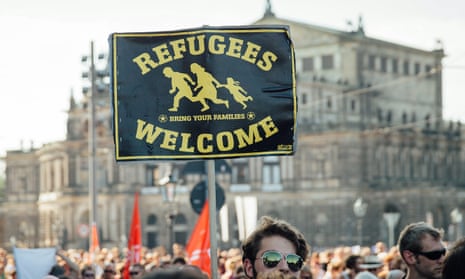 A demonstrator holds a sign that reads ‘refugees welcome’ on Saturday.