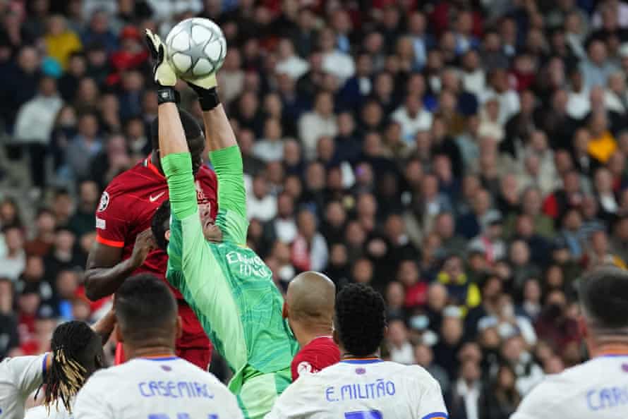 Real Madrid’s goalkeeper Thibaut beats Liverpool’s Ibrahima Konate to the ball.