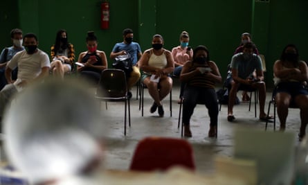 People wait for Covid-19 tests in the Santa Marta favela, Rio de Janeiro, Brazil.