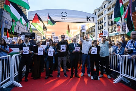 Spanish film industry members show support for NAZA’s directors at the San Sebastian International film festival by waving Palestinian flags and holding posters saying ‘We Are Naza’