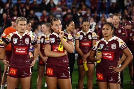 Members of the Maroons look on after game three