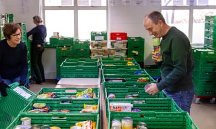 volunteers sort produce at a food bank warehouse in kingston upon thames, surrey