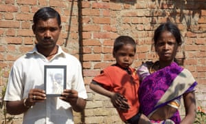 Devganga Sawra, seen here with his wife Sunder and younger son, holds an image of their son Vishwarnam, who died of malnutrition in September