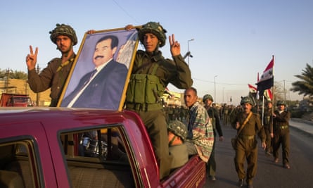Members of the Ba’ath socialist party broadcast their support for Saddam Hussein in Baghdad, Iraq, 2 March 2003.