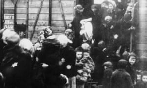Mothers with their children step off the train bringing them to the Auschwitz-Birkenau death camp in Nazi-occupied Poland.