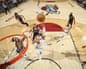 Jalen Brunson shoots the ball near the basket during a game, with defenders nearby