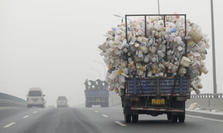 A truck loaded with used plastic bottles on a road in Beijing