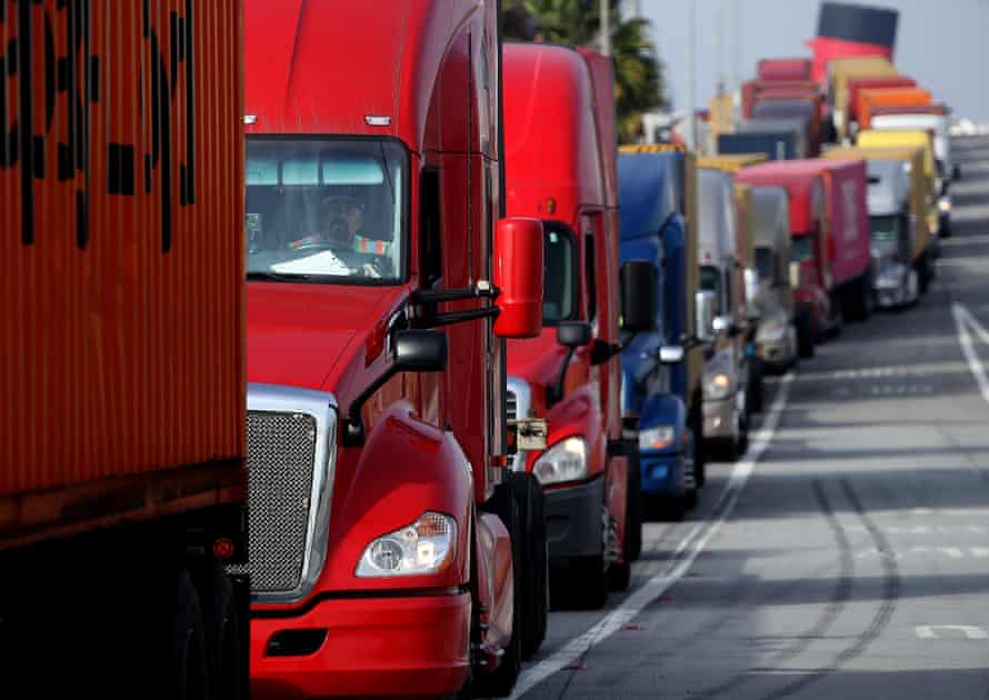 Trucks idle in a long line as drivers wait to enter a shipping terminal in the Port of Long Beach in November.