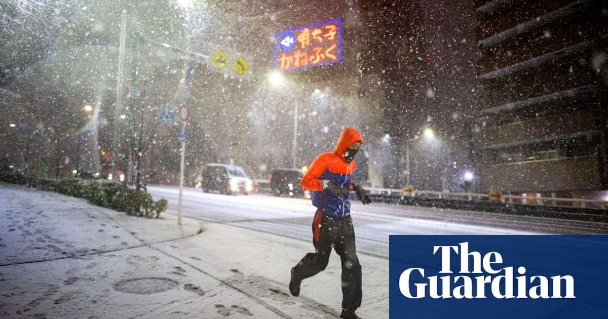 Tokyo snow: first flurries of the year land in the Japanese capital – in pictures