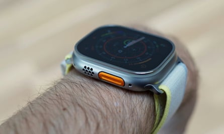 The speaker grille next to the orange action button of the Apple Watch Ultra.
