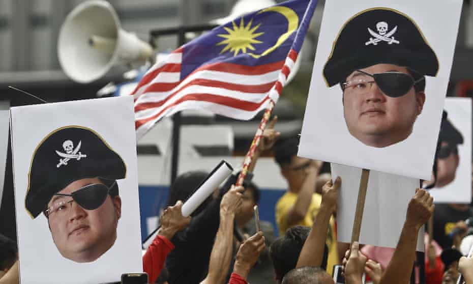 Protesters hold portraits of Jho Low, who was charged with money laundering on Thursday, during a protest in Kuala Lumpur, Malaysia, on 14 April.