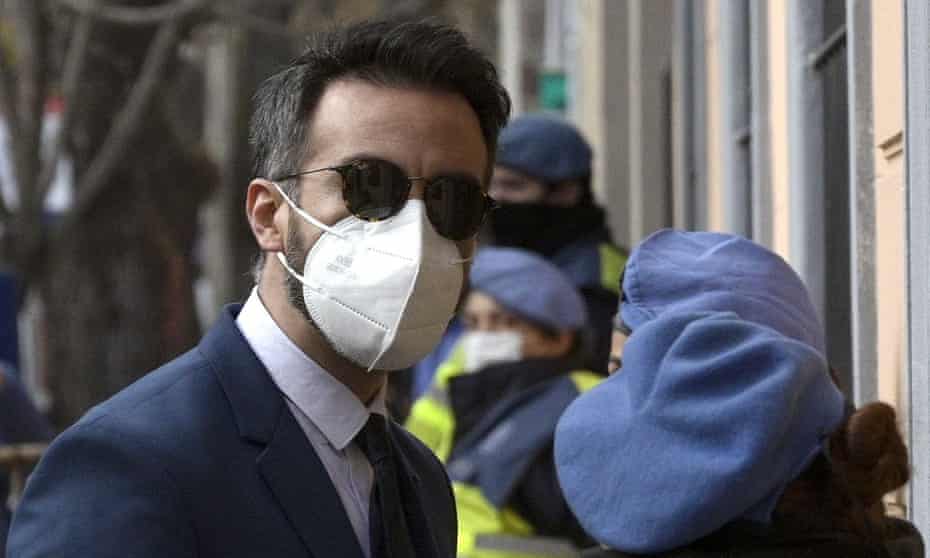Man in suit and tie wearing mask