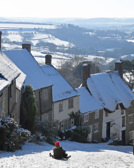 A toboggan steers down Gold Hill in Shaftesbury, Dorset, on Saturday.