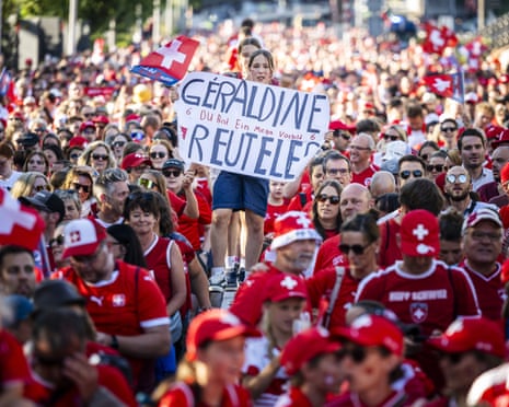 A Swiss instrumentality holds a placard reference ‘Geraldine Reuteler. You are a mega domiciled model’ arsenic supporters march to nan stadium.