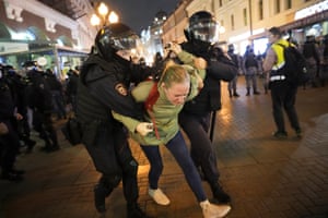 Riot police restrain a demonstrator in Moscow