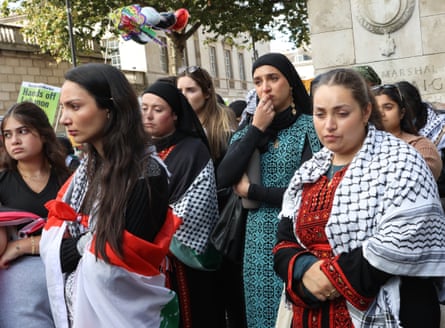 People break down in tears during a minute’s silence.