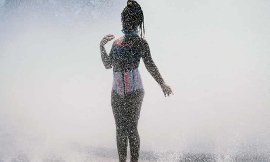 A girl cools off in the Salmon Street springs fountain in Portland