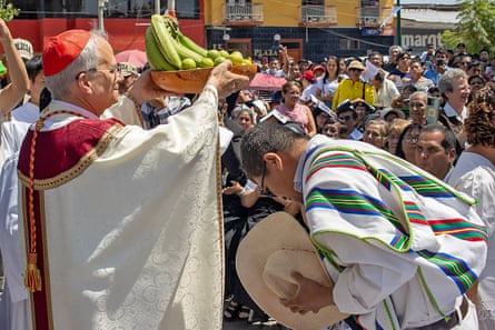 a clergyman receives a plate of fruit