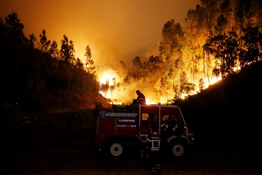 Firefighters work to put out a fire near Bouça Photograph: Rafael Marchante/Reuters Firefighters work to put out a fire near Bouça Photograph: Rafael Marchante/Reuters