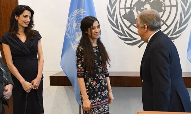 The UN secretary-general, António Guterres, and Yazidi activist Nadia Murad speak as Amal Clooney looks on at the United Nations Headquarters in New York.