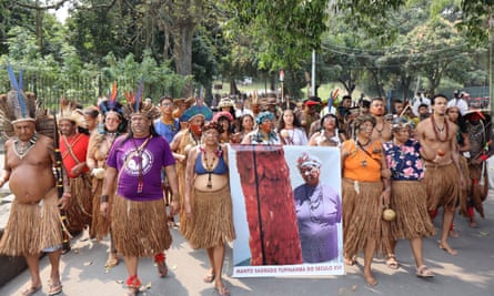 large group of people in ceremonial clothing walking