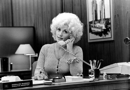 Woman on phone sits at desk
