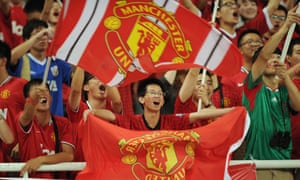 Manchester United fans wait for the start of a friendly against Shanghai Shenhua in the Chinese city in 2012.