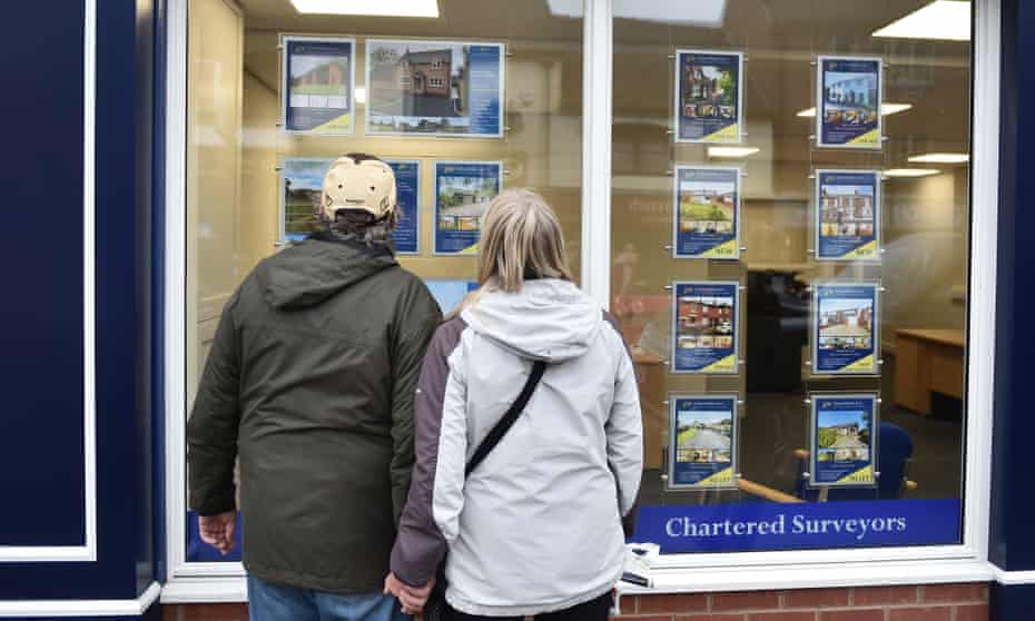 Home-seekers in Leek, Staffordshire view an estate agent window